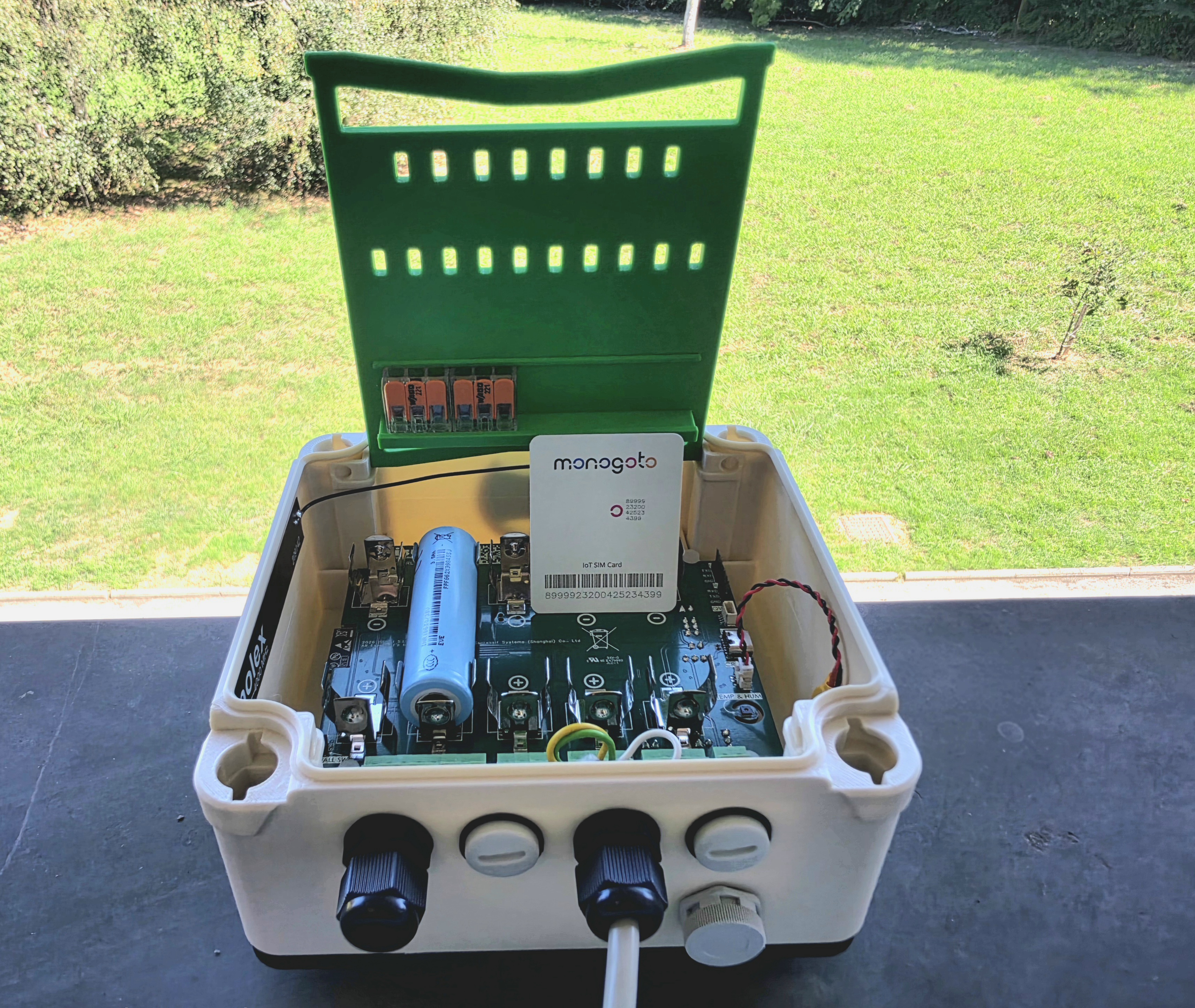 ISURLOG open outdoors, with the Monogoto NTN SIM card sitting on the board